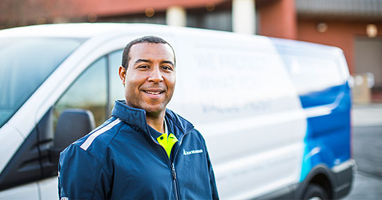 How our mountaineer can help you transform your business- A man smiling with an Iron Mountain truck in the background